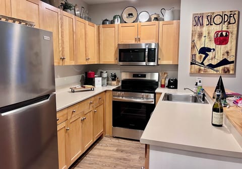 Functional kitchen supplied with everything you need! Open to living space.