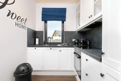 Kitchenette with oven and refrigerator. 