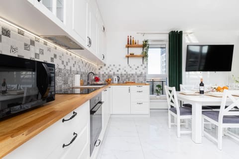 Kitchenette with oven and refrigerator. 