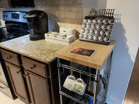 Stocked coffee station with flavored and unflavored coffee, cream, sugar