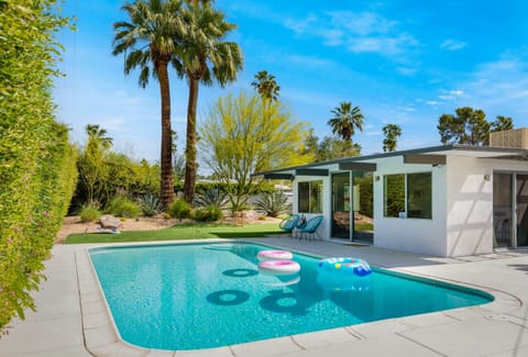 Enjoy a beautiful pool area surrounded by a vibrant desert garden