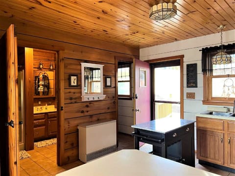 Looking from kitchen peninsula toward bathroom, mudroom, entry door
