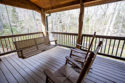 Wooden Porch Swing and Wicker Rocking Chairs on the Main Covered Porch
