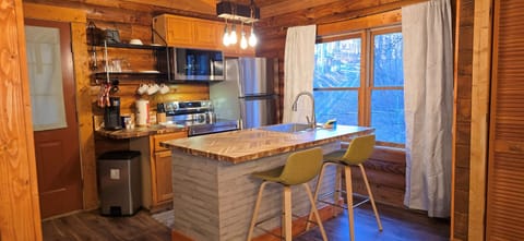 Gather around the kitchen island for snacks, stories, and connection in the heart of the cabin.