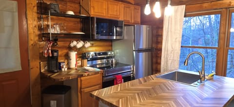 This fully equipped kitchen blends rustic warmth with modern convenience, making mealtime a true cabin delight.
