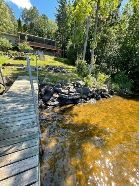 Shoreline with a rocky shoreline, sand bottom with natural vegetation.