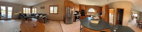 Panoramic photo showing dinning area and kitchen