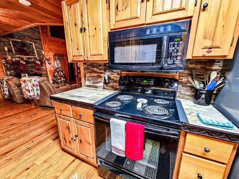 View of the kitchen showing electric stove and microwave