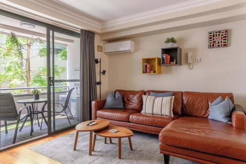 Cool comfort with AC and a plush couch. Access your private balcony seating right from the living room. Perfect space for relaxing or connecting.
