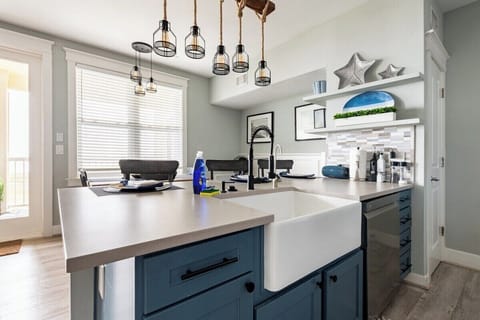 Farmhouse sink with seating for three at bar and water views. Filtered water.