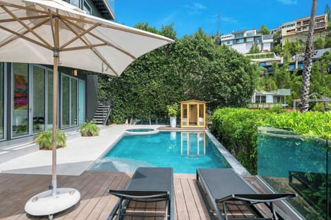 Outdoor area with pool, outdoor seating, indoor-outdoor fun room connecting the pool to the inside of the home