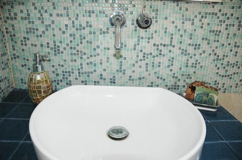 Mosaic tiled bathroom sink area