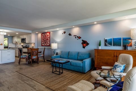 Comfortable living space with a cozy couch & stylish decor, flowing into the dining & kitchen areas.