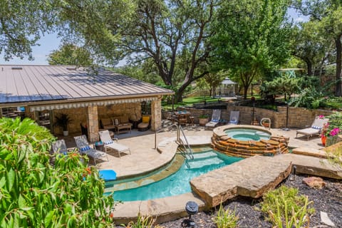 A large resort-style shade umbrella has been added over the hot tub. 