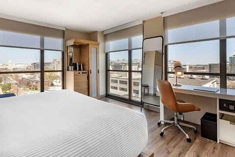 Wake up to panoramic city views from your plush bed.