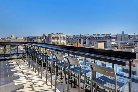 Stretch out on rooftop sofas with stadium and city views.