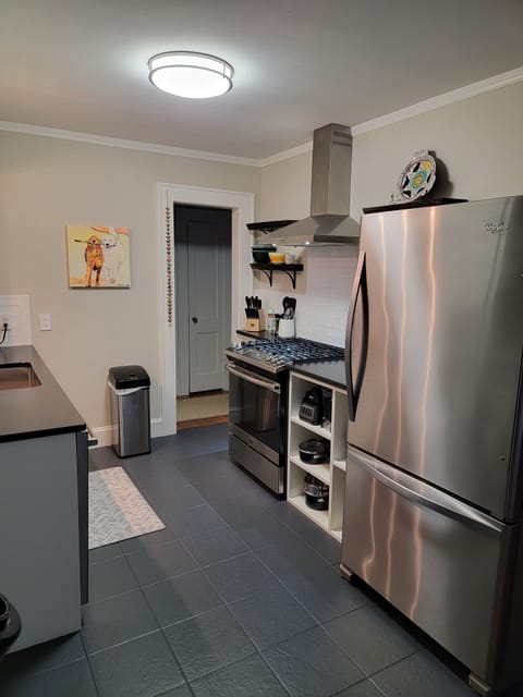 Galley Kitchen w/gas range/oven and large capacity refrigerator, dishwasher, etc