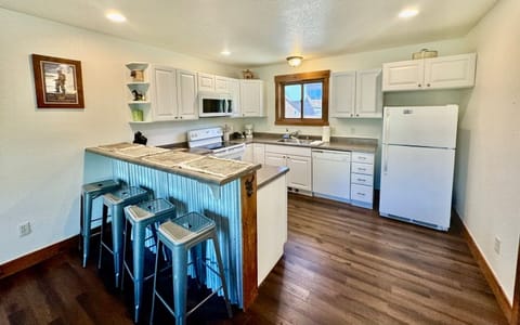 a fully equipped kitchen with a breakfast bar for casual dining or morning coffee.
