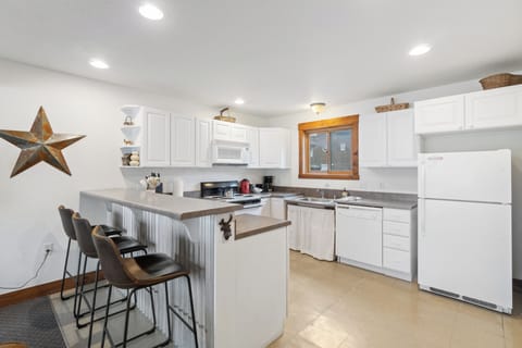 A fully equipped kitchen with a breakfast bar for casual dining or morning coffee.