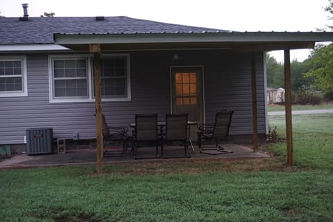 Covered back porch for outdoor entertaining. Complete with BBQ and firepit