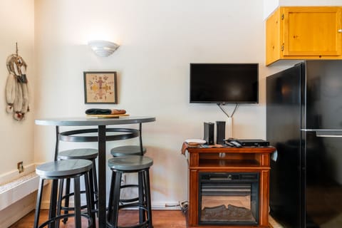 TV and small dining area in the living room.