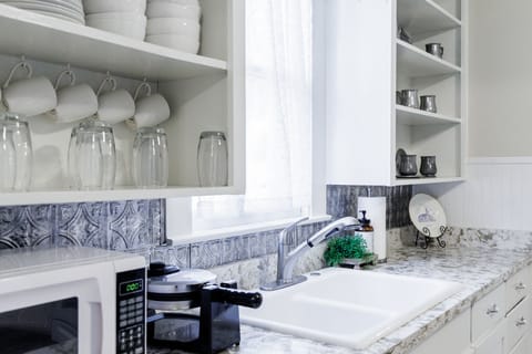Bright kitchen with marble counters and sink • Modern comfort, classic charm