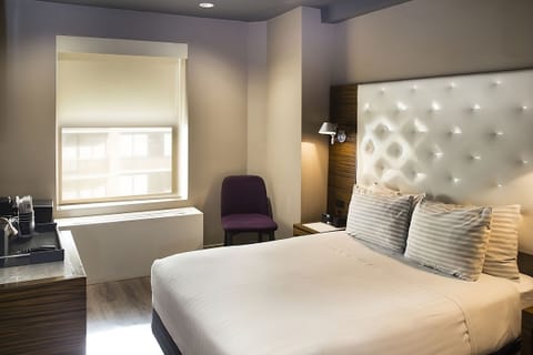 Drift off in a cozy king bed under soft lighting.