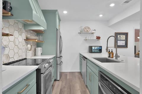 Microwave drawer, dishwasher, full sized fridge, oven, toaster oven, pots & pans, cookie sheet, cutting boards, pyrex storage containers.