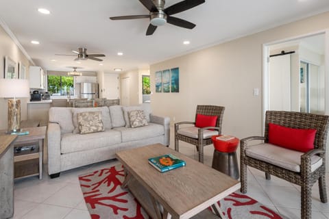 Living room with sliding doors to lanai and peekaboo ocean views