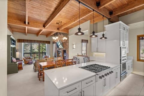 Step into your gourmet kitchen where rustic charm meets modern luxury. Cook while chatting with loved ones in the open dining space under gorgeous exposed beams and pendant lights.