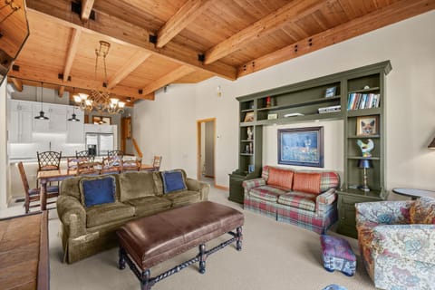 Relax in your charming living space where rustic wood beams meet cozy comfort. Sink into plush sofas while enjoying your favorite shows on the built-in entertainment center, surrounded by warm touches that make this feel like your mountain home away from h