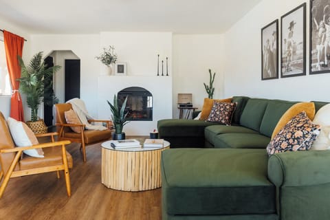 Cozy living room with fireplace, chess table, smart TV, vinyl player, VHS player