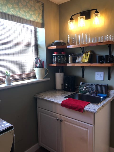 Kitchenette with microwave, toaster oven, coffee maker, tea kettle and blender.