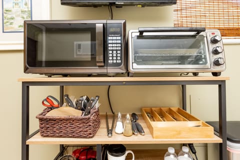 Kitchenette with microwave, toaster oven, coffee maker, tea kettle and blender.