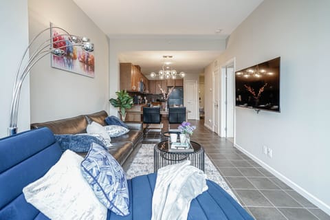 Full size leather sofa and a comfy lounger to watch shows on a 55" TV