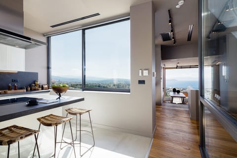 The kitchen island with three hand-woven stools is bound to accommodate all our guests’ needs.