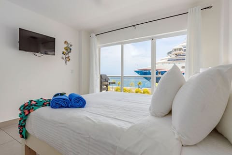Wake up to sparkling ocean views and cruise ships drifting by—your bright, airy bedroom offers a front-row seat to coastal bliss and total relaxation.