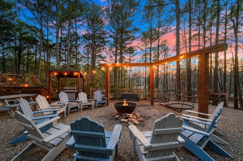 A cozy escape in the heart of the woods—warm fire, open sky, and pure serenity.