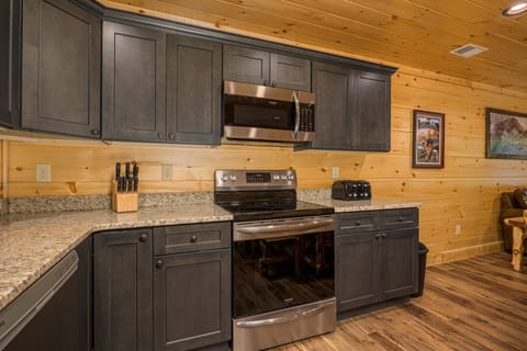 Beautiful kitchen has a drip coffee maker, k-cup coffe maker and small appliances as well as dishes, silverware, pots and pans and a crock pot