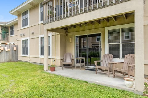 Modern two-story vacation rental featuring a covered patio with comfortable seating and private yard space.
