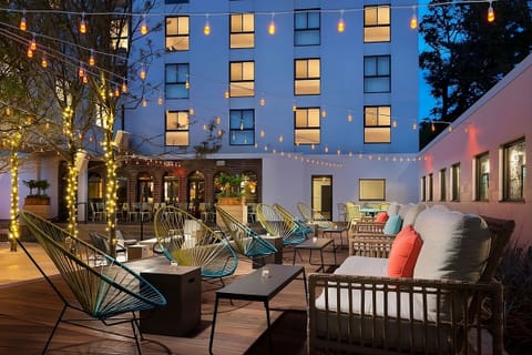 Unwind under twinkling lights in a lively open-air courtyard.