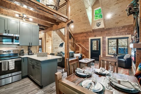A view of the kitchen, living room and loft from the back door on the main level.