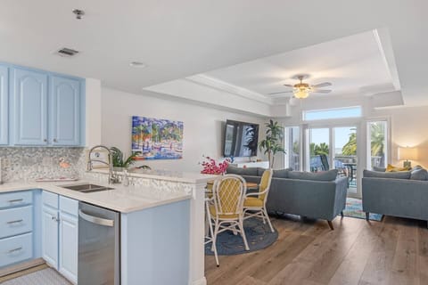 Kitchen looking into living room and balcony