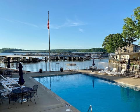 Large heated pool with view of lake and plenty of seating