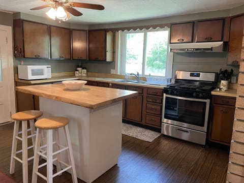 Kitchen with island and 2 stools