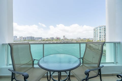 Balcony view from one of the rooms with small table and chairs.