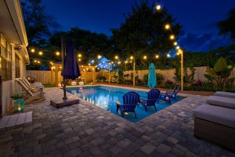Evening by the pool under the glow of string lights