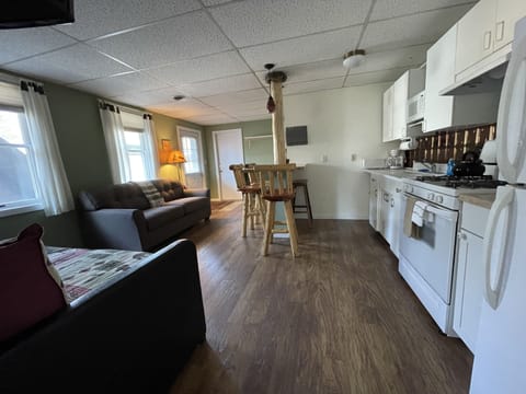 eat -n kitchen with bar top and bar stools