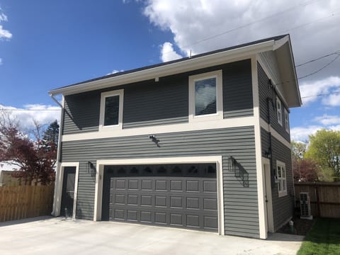 Detached garage with apartment entrance left of the garage door 