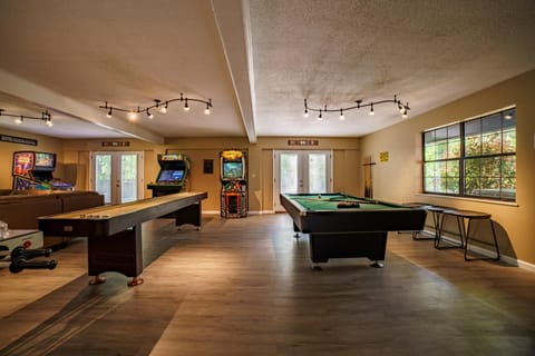 Game room with lots of games and 75 inch smart TV to catch the game or show. 